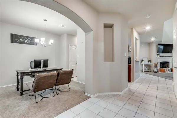 a view of a livingroom with workspace and a window