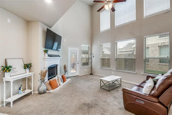 a living room with furniture a fireplace and a flat screen tv