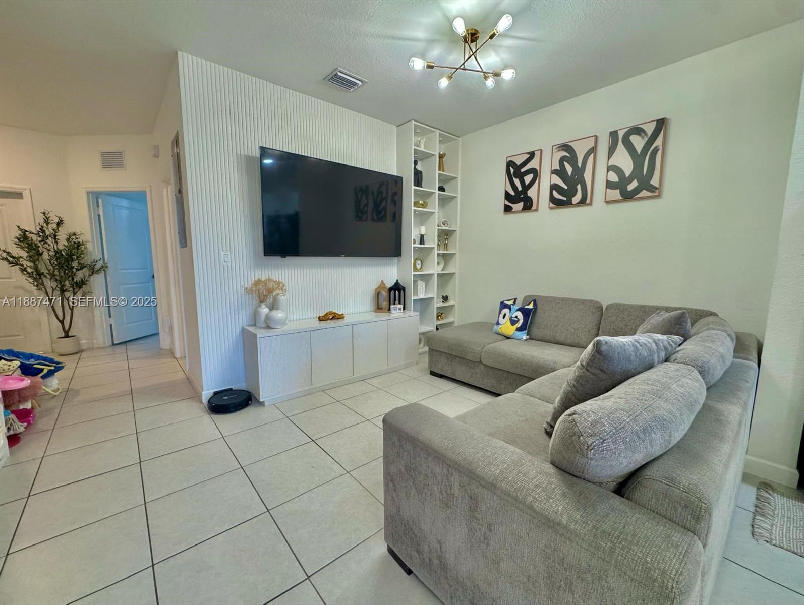 23541 Southwest 127th Place Homestead, FL 33032 - Photo 11 of 13 a living room with furniture and a flat screen tv