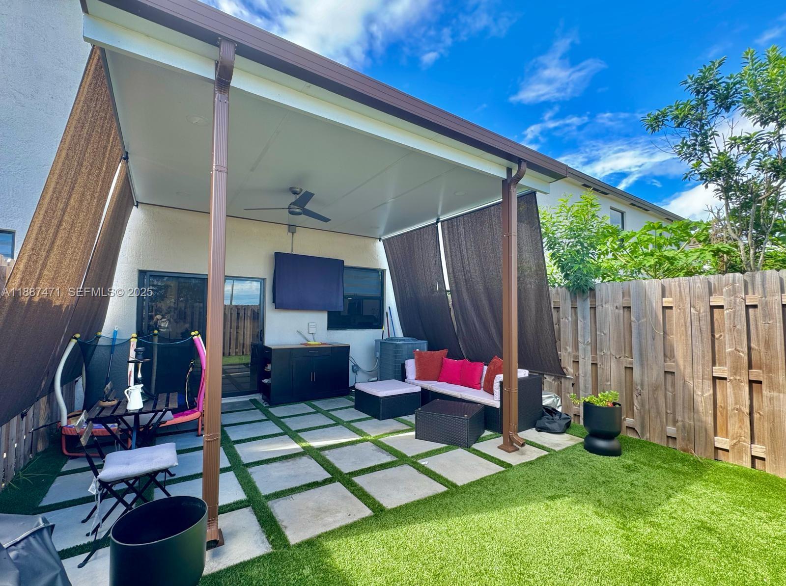 23541 Southwest 127th Place Homestead, FL 33032 - Photo 13 of 13 a backyard of a house with seating space
