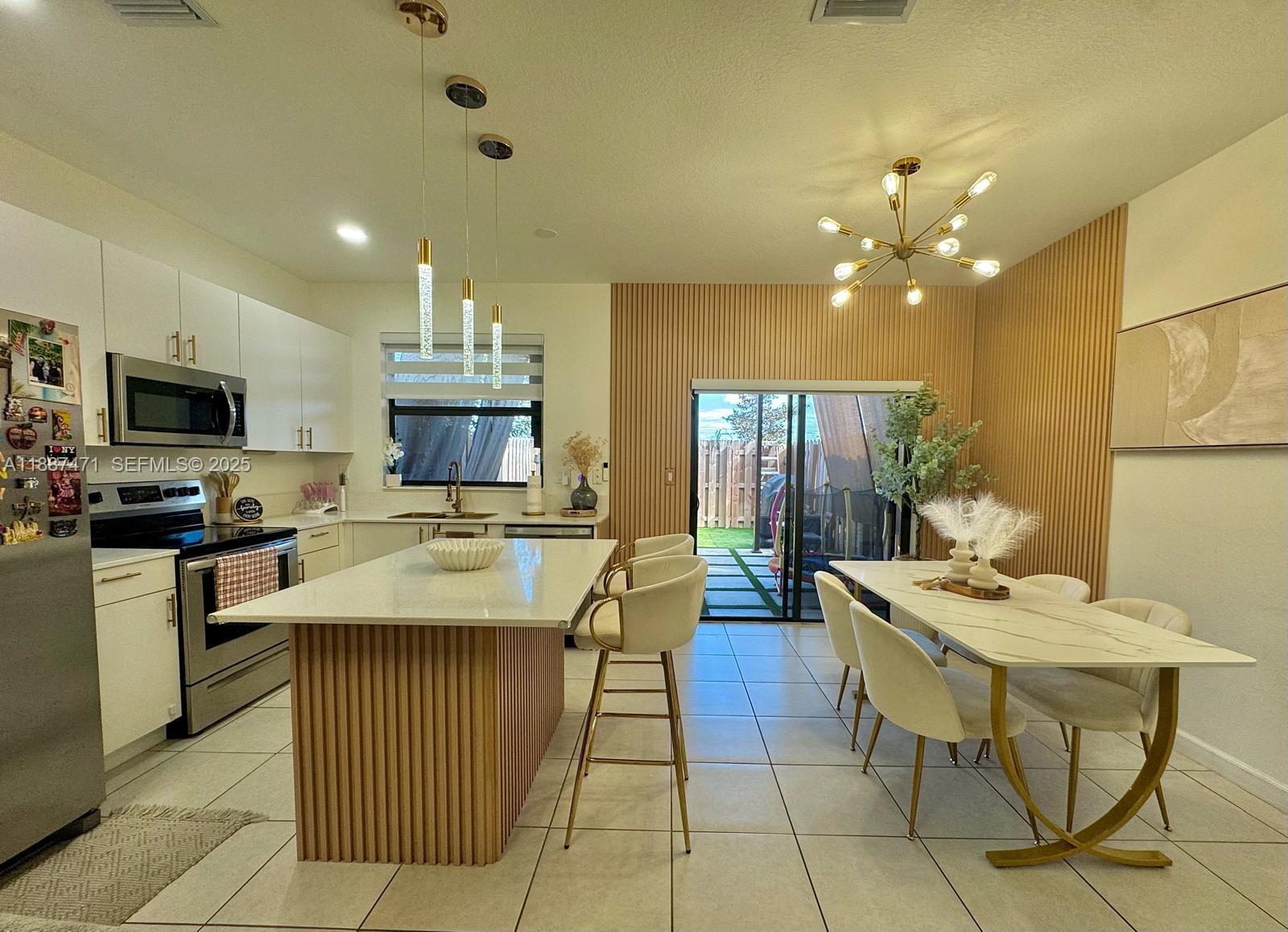 23541 Southwest 127th Place Homestead, FL 33032 - Photo 8 of 13 a kitchen with a table and chairs in it