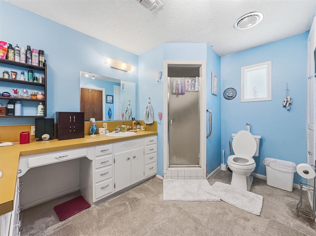 112 East Hoard Street Hamilton, TX 76531 - Photo 12 of 26 a bathroom with a toilet sink and mirror