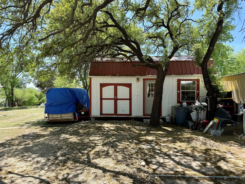 112 East Hoard Street Hamilton, TX 76531 - Photo 23 of 26 a front view of a house with a tree