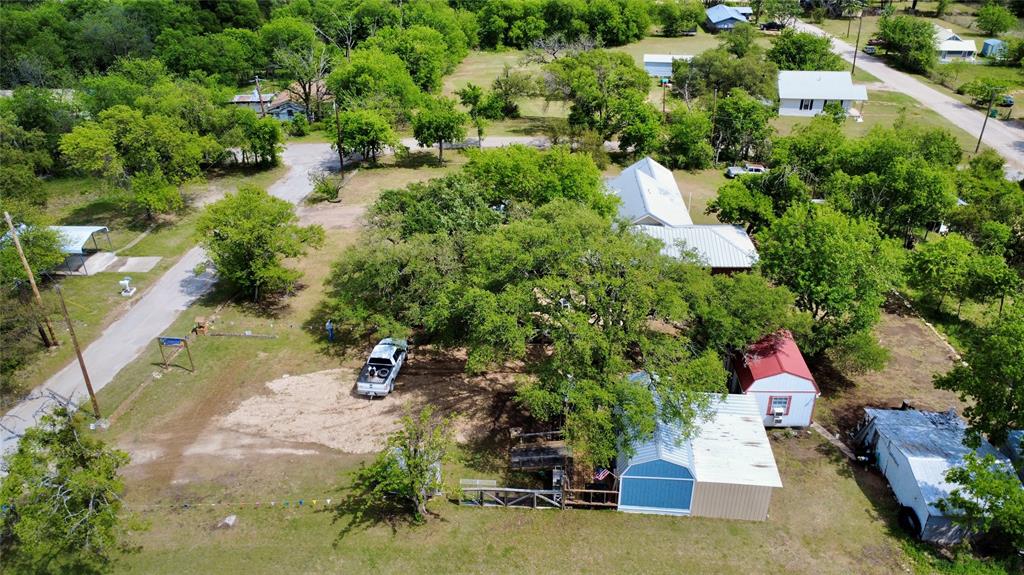 112 East Hoard Street Hamilton, TX 76531 - Photo 24 of 26 an aerial view of a house with a yard and lake view