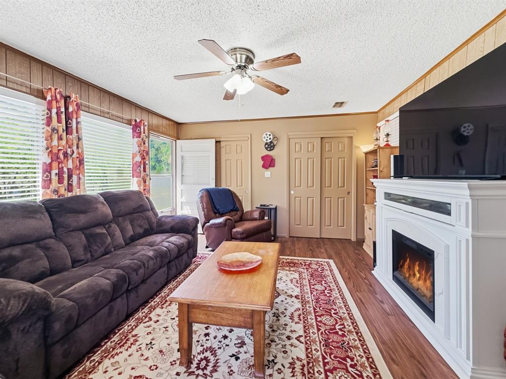 112 East Hoard Street Hamilton, TX 76531 - Photo 3 of 26 a living room with furniture and a fireplace