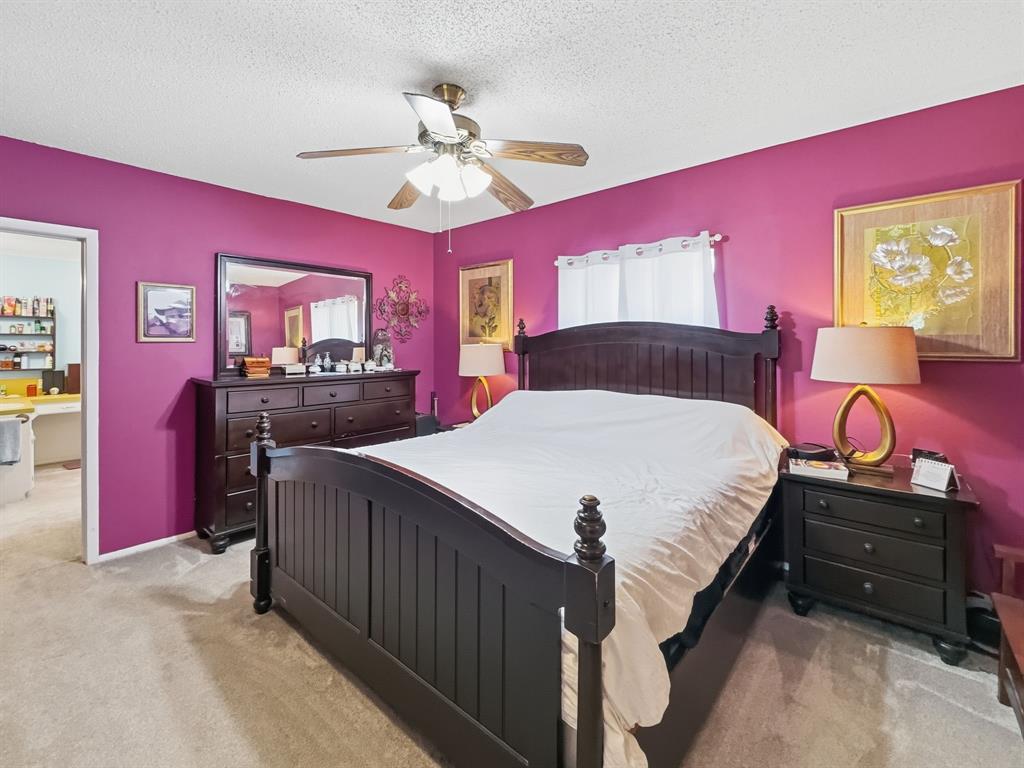 112 East Hoard Street Hamilton, TX 76531 - Photo 7 of 26 a bed room with a bed and a chandelier