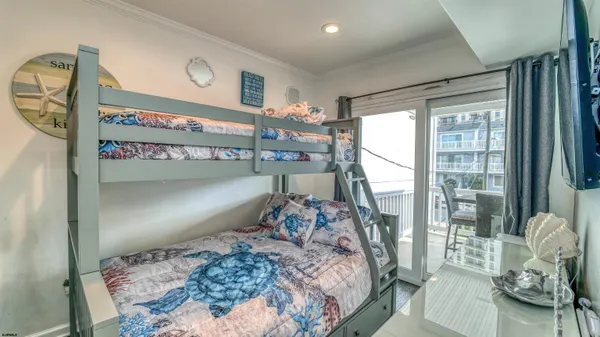 a bedroom with a large bed and a large window
