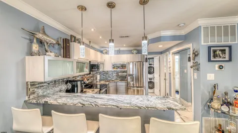 a large kitchen with kitchen island a sink stove and refrigerator