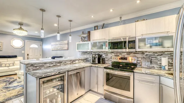 a kitchen with stainless steel appliances granite countertop a stove sink and cabinets