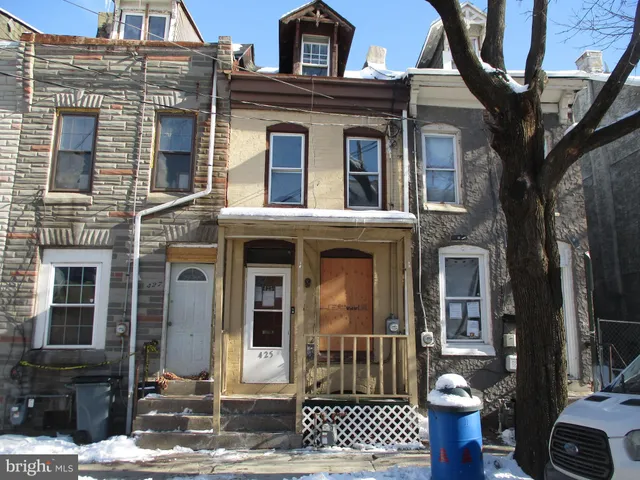 a view of a brick house with large windows