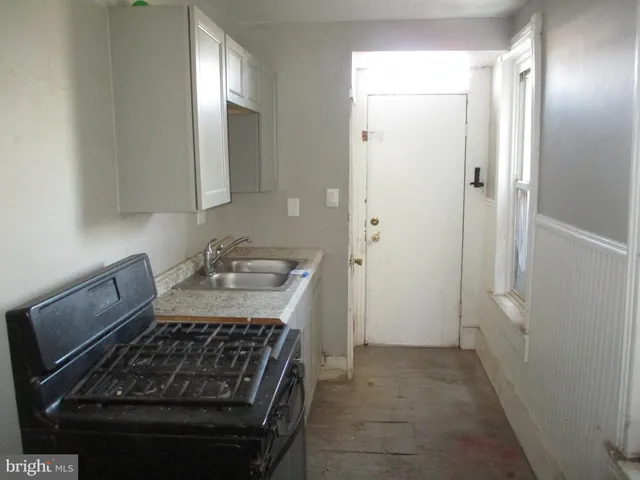 a kitchen with a stove and a refrigerator
