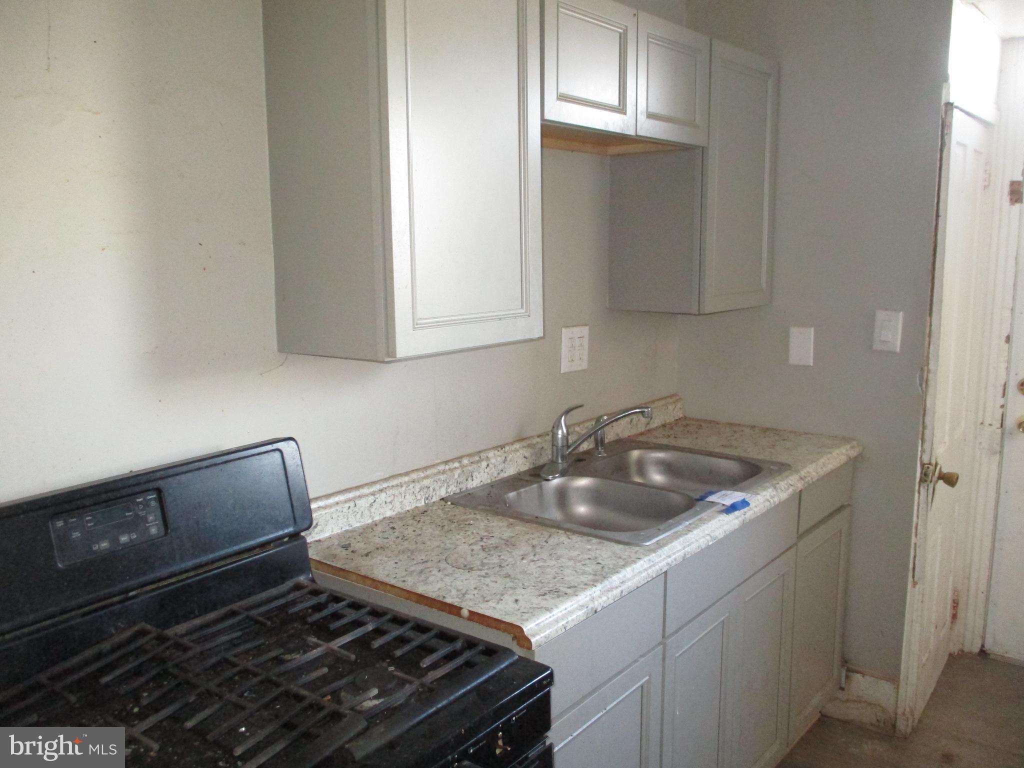 425 North 2nd Street Reading, PA 19601 - Photo 7 of 16 a kitchen with granite countertop a sink stove and cabinets