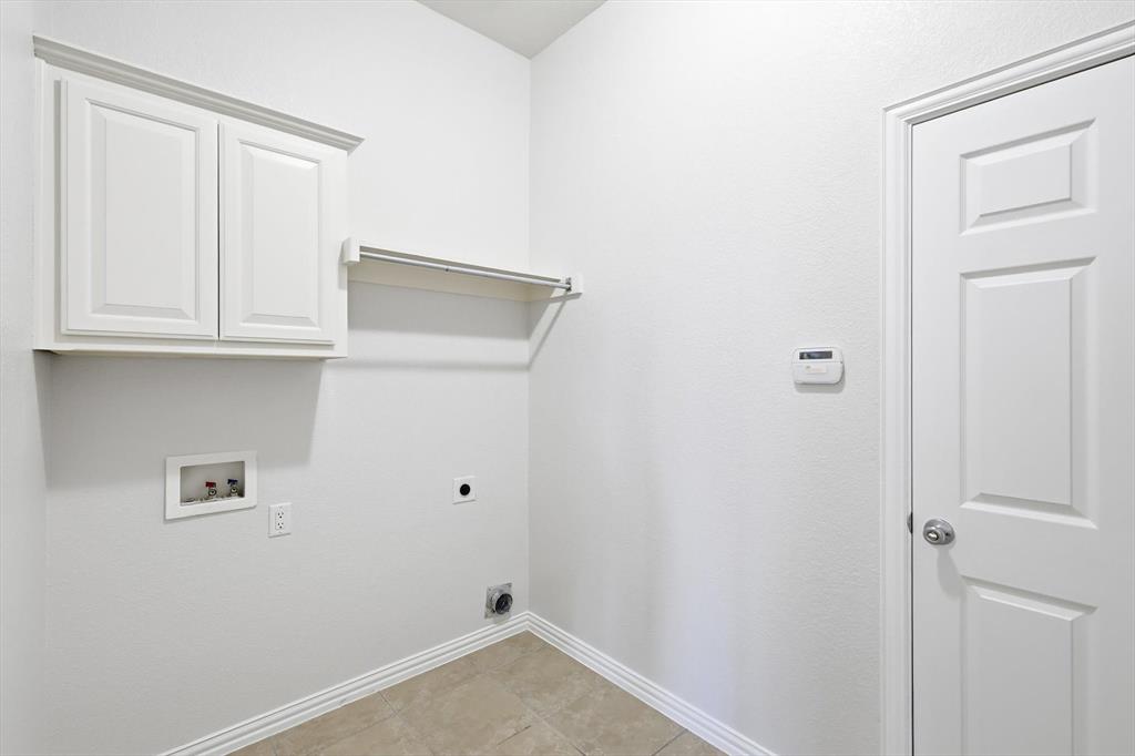 9728 Sam Bass Trail Fort Worth, TX 76244 - Photo 18 of 34 Laundry area featuring hookup for an electric dryer, hookup for a washing machine, and cabinet space