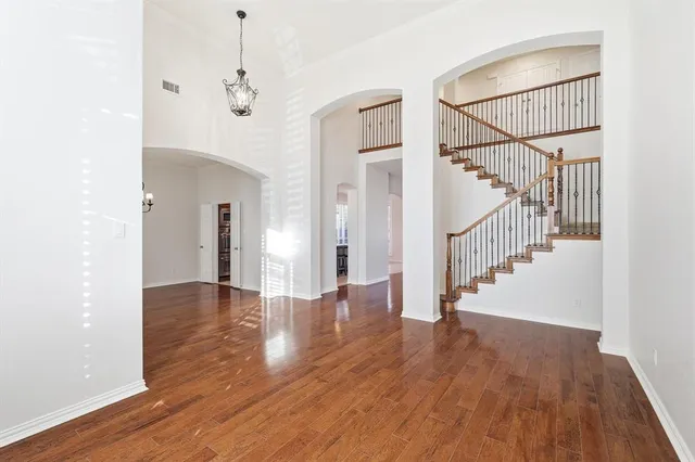 a view of entryway and hall with wooden floor