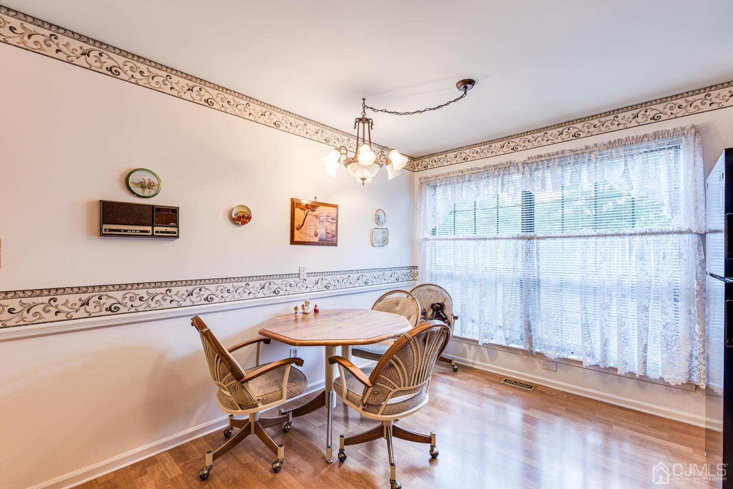 4303 Springbrook Drive Edison, NJ 08820 - Photo 21 of 40 a dining room with a wooden table and chairs