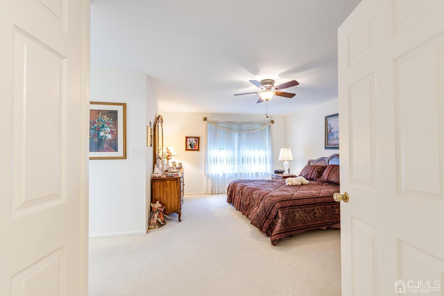 4303 Springbrook Drive Edison, NJ 08820 - Photo 23 of 40 a bed room with a bed and a ceiling fan