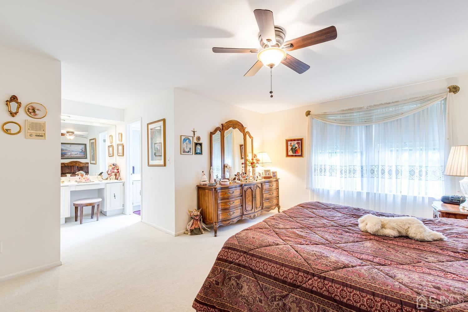 4303 Springbrook Drive Edison, NJ 08820 - Photo 25 of 40 a bedroom with a large bed a chandelier and a window