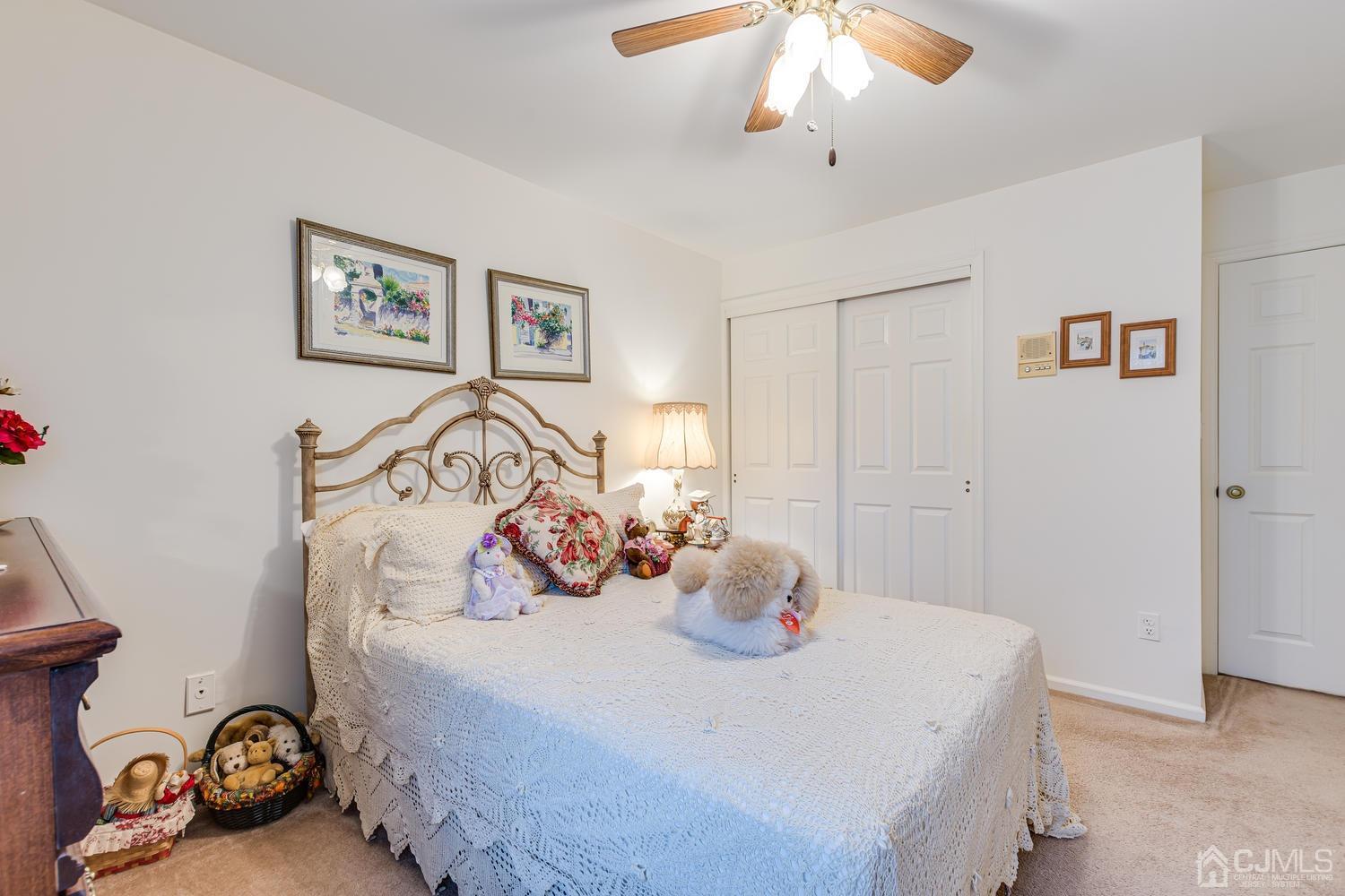 4303 Springbrook Drive Edison, NJ 08820 - Photo 29 of 40 a bedroom with a bed and a chandelier