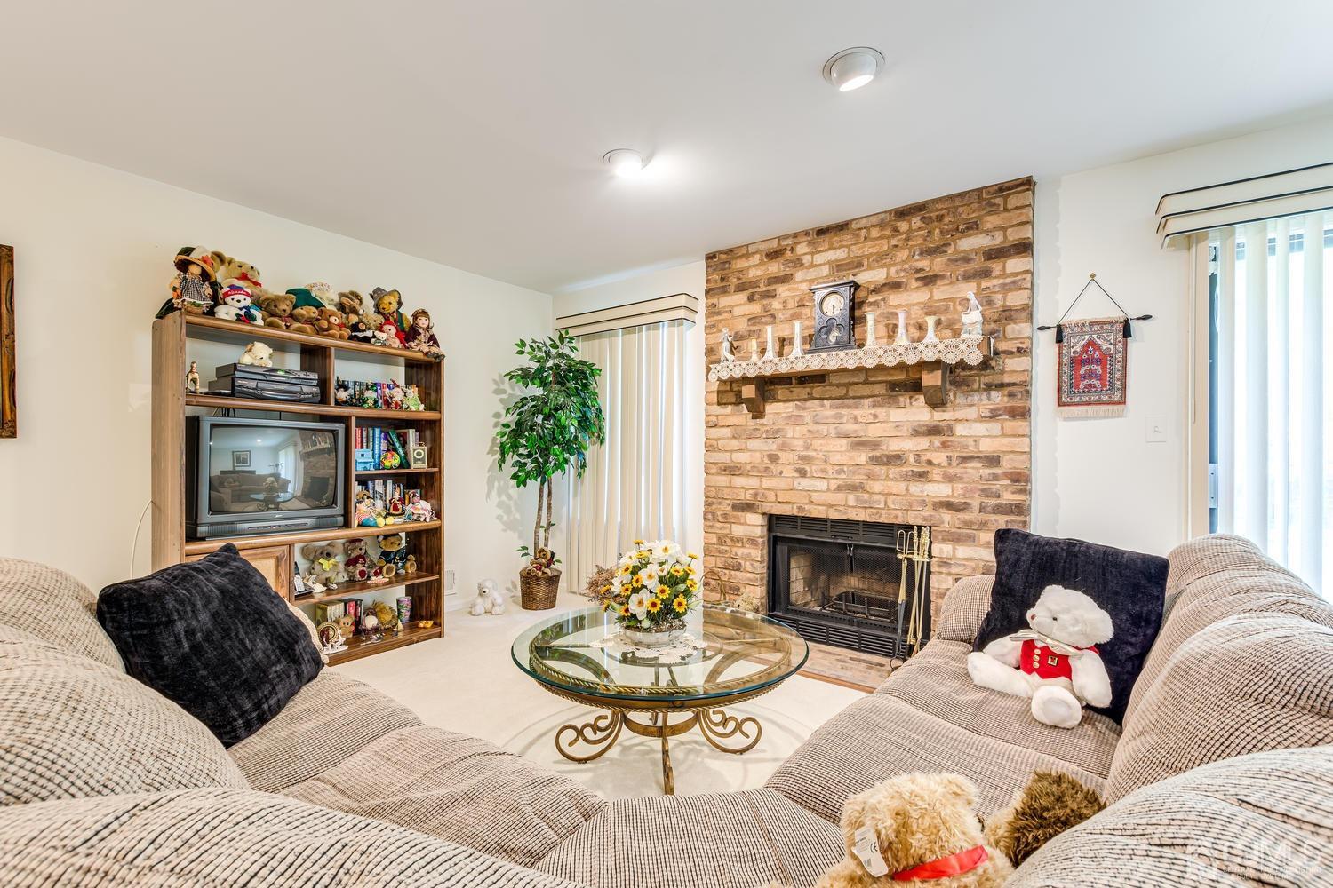 4303 Springbrook Drive Edison, NJ 08820 - Photo 34 of 40 a living room with furniture and a fireplace