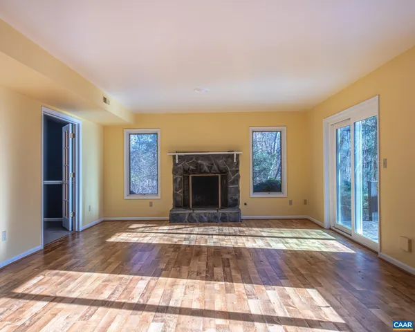 a bathroom with a granite countertop toilet a sink and a mirror
