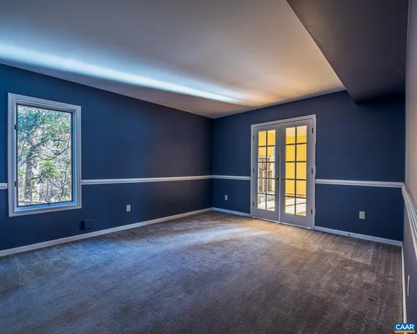 an empty room with windows and closet