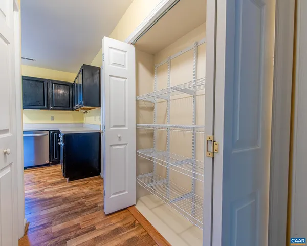 a kitchen with kitchen island wooden cabinets and refrigerator