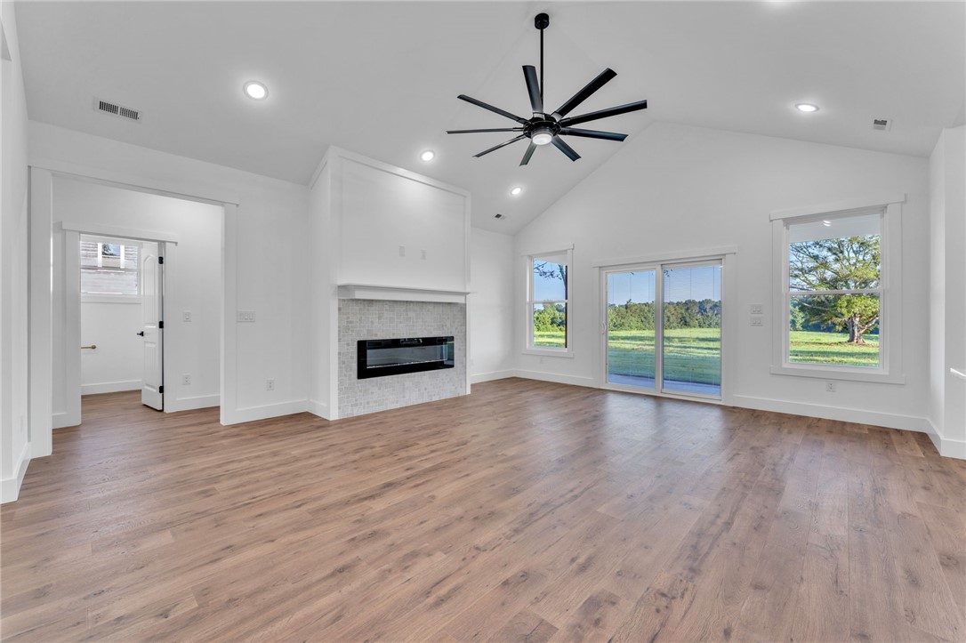 1725 Harris Bridge Road Anderson, SC 29621 - Photo 5 of 33 A spacious living area with soaring vaulted ceilings and expansive views of the outdoors.