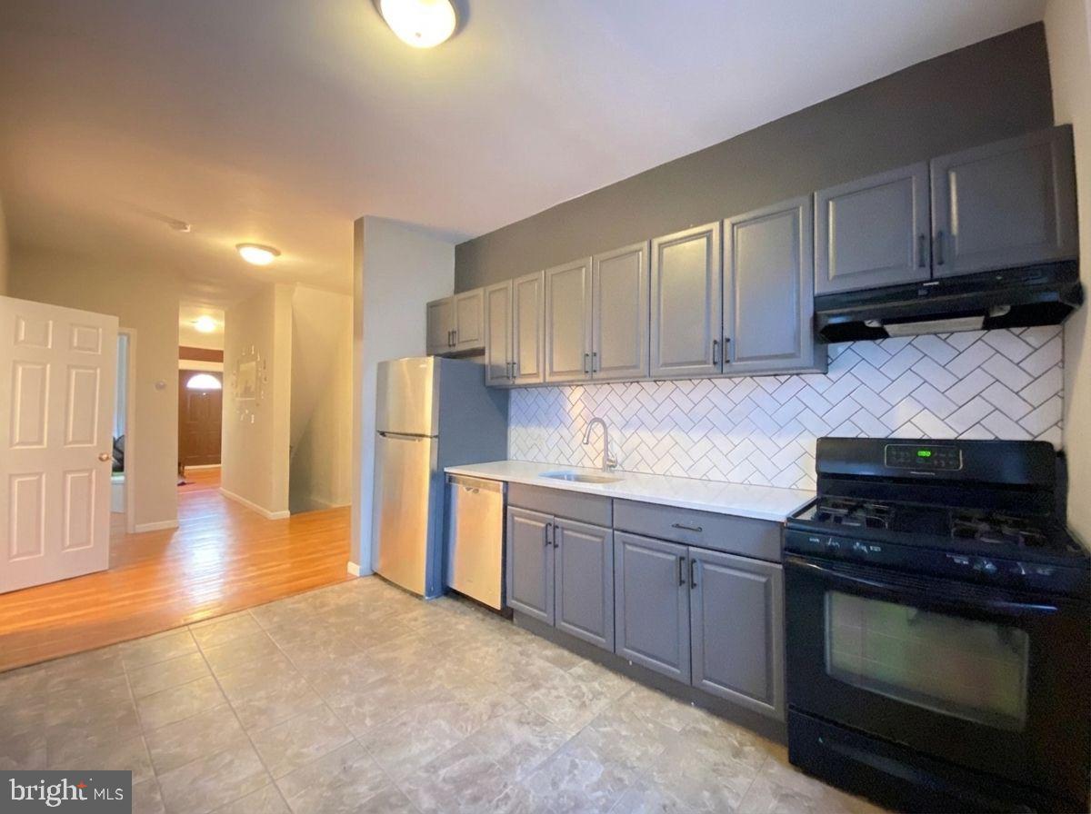 a kitchen with granite countertop a stove and a sink