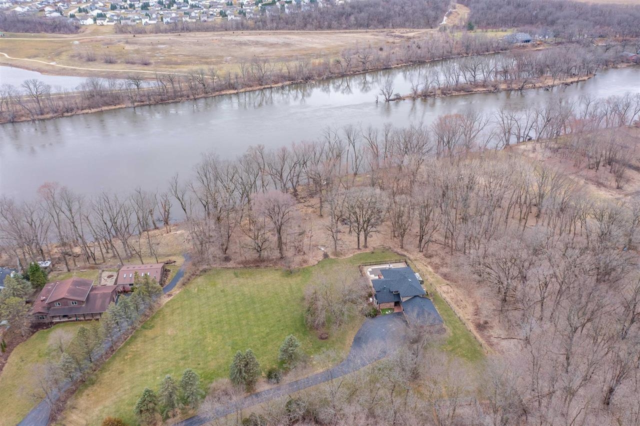 11640 Bend River Road Roscoe, IL 61073 - Photo 1 of 9 a view of a lake in between of two large trees