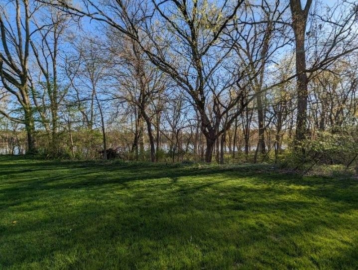 11640 Bend River Road Roscoe, IL 61073 - Photo 3 of 9 a yard with trees in the background