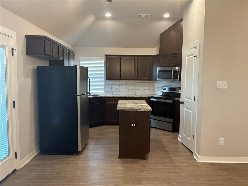 2834 Messenger Way Bryan, TX 77803 - Photo 11 of 24 a kitchen with a refrigerator and a sink