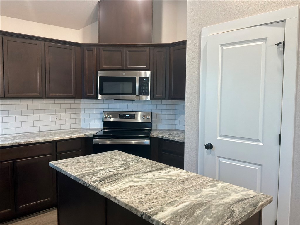2834 Messenger Way Bryan, TX 77803 - Photo 13 of 24 a kitchen with a stove and a microwave