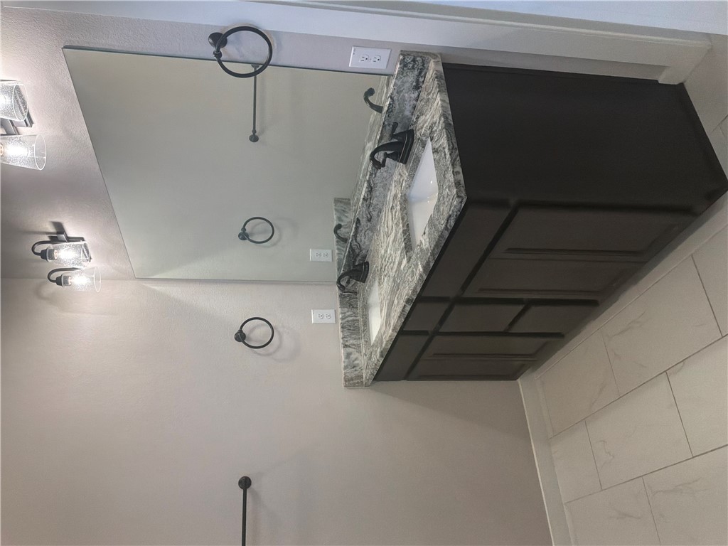 2834 Messenger Way Bryan, TX 77803 - Photo 21 of 24 a bathroom with a granite countertop sink and a mirror