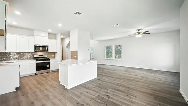 a view of kitchen with cabinets and wooden floor