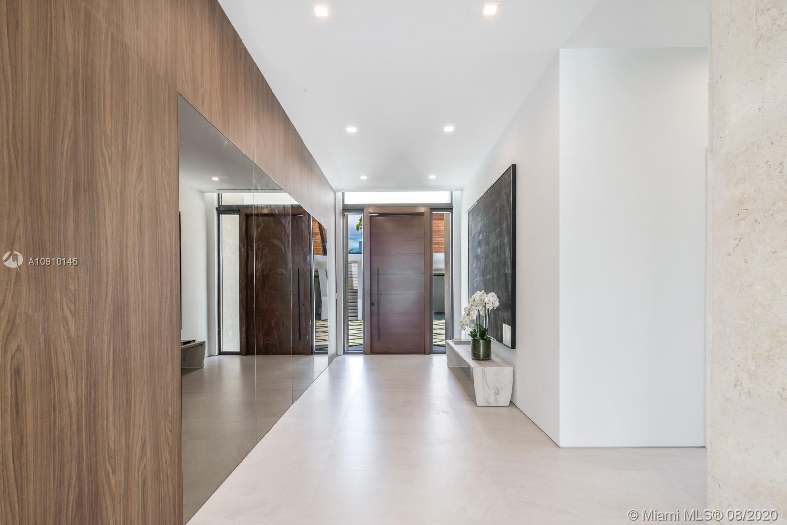 6493 Allison Road Miami Beach, FL 33141 - Photo 13 of 41 a hallway with wooden floor and windows