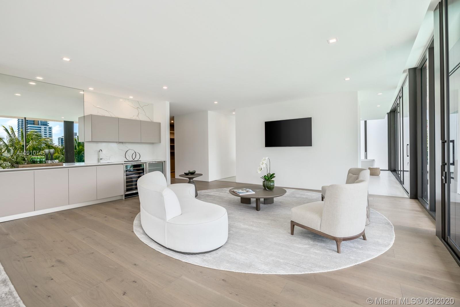 6493 Allison Road Miami Beach, FL 33141 - Photo 17 of 41 a living room with couches and a flat screen tv