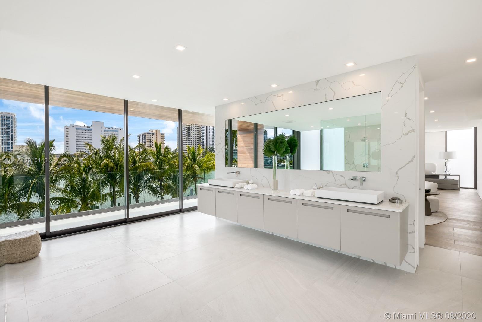 6493 Allison Road Miami Beach, FL 33141 - Photo 19 of 41 a large white kitchen with a large window and double vanity