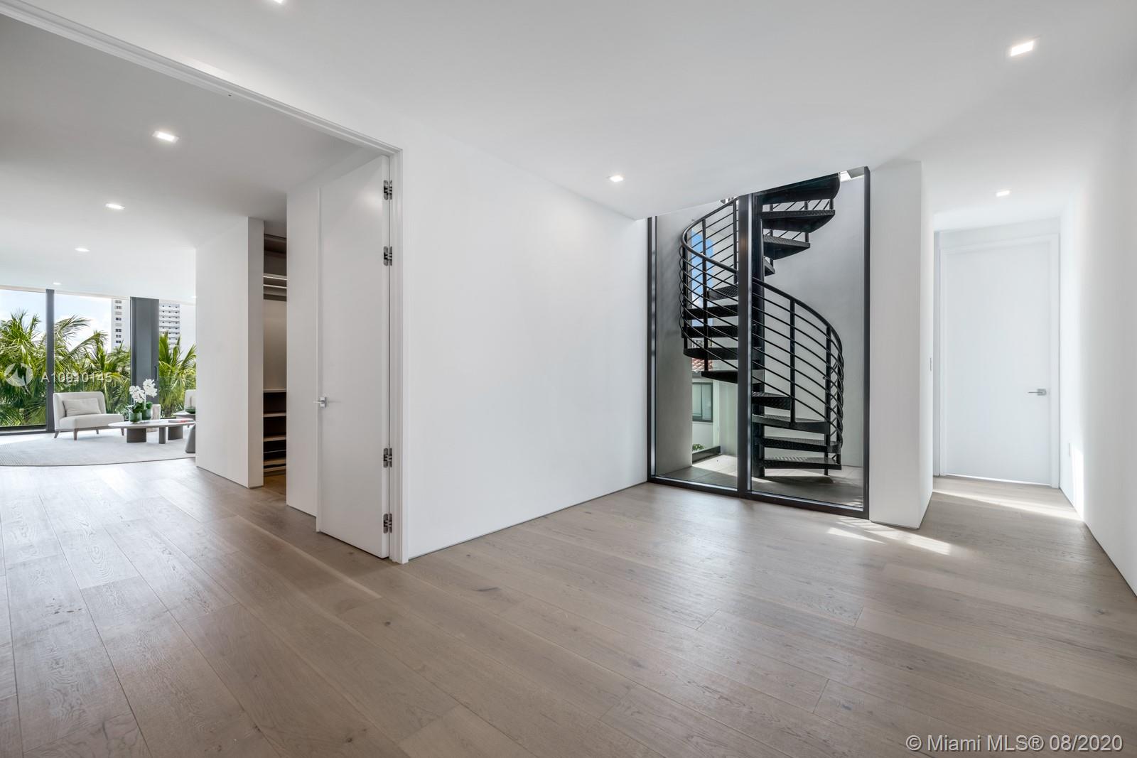 6493 Allison Road Miami Beach, FL 33141 - Photo 26 of 41 a view of an empty room with wooden floor and windows