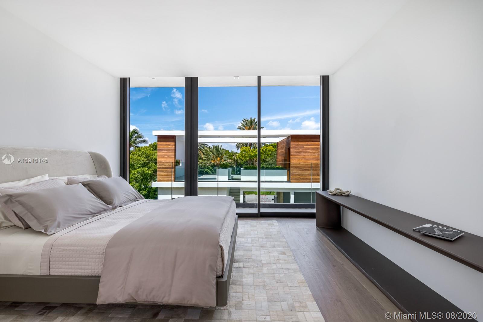 6493 Allison Road Miami Beach, FL 33141 - Photo 27 of 41 a bedroom with a bed and a large window