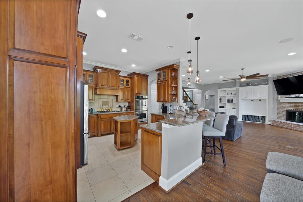 621 Diamond Point Drive Oak Point, TX 75068 - Photo 12 of 40 a view of a dining room kitchen with furniture a chandelier and wooden floor