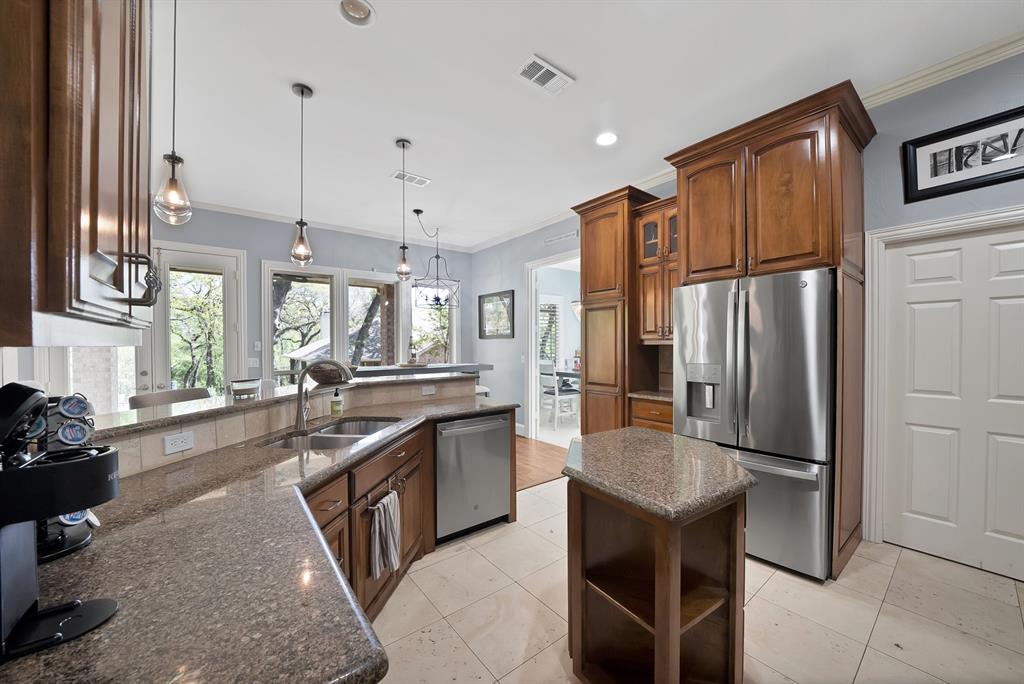 621 Diamond Point Drive Oak Point, TX 75068 - Photo 14 of 40 a kitchen with stainless steel appliances granite countertop a refrigerator a stove a sink and a refrigerator