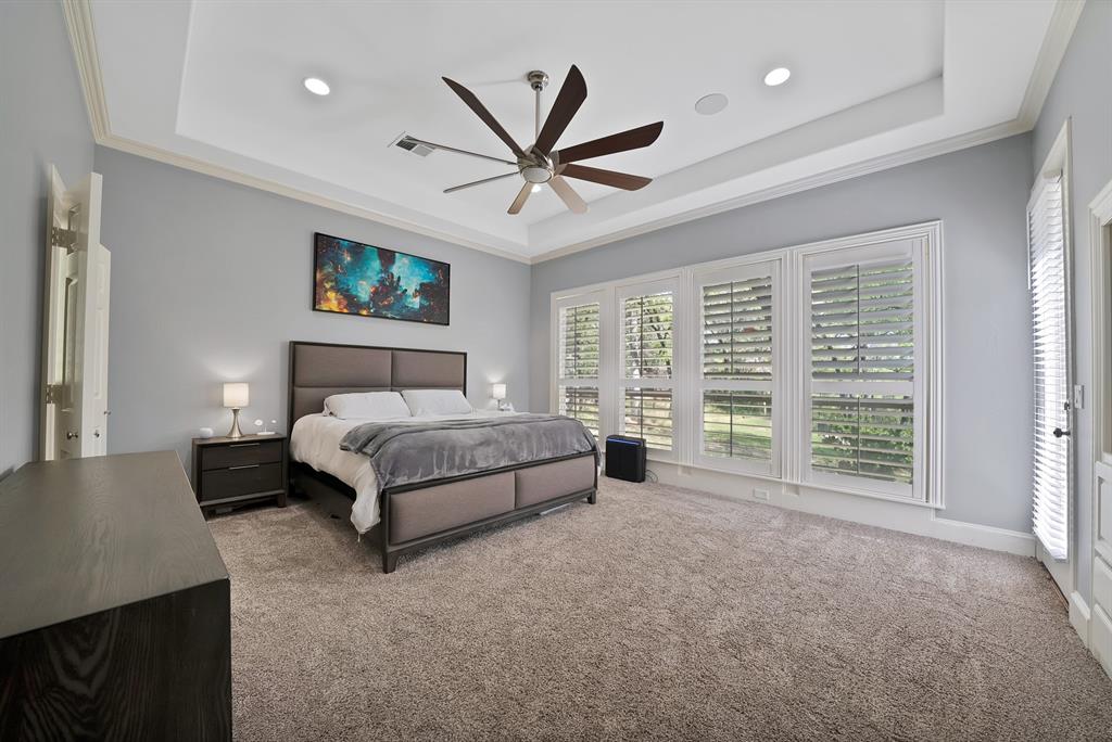 621 Diamond Point Drive Oak Point, TX 75068 - Photo 17 of 40 a spacious bedroom with a bed a table and a large window