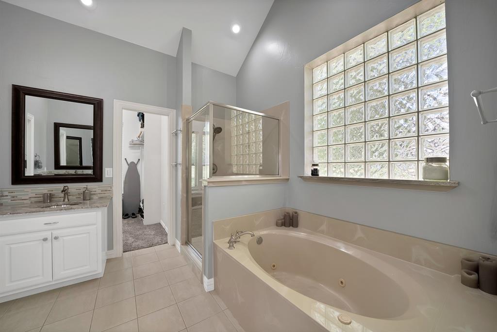 621 Diamond Point Drive Oak Point, TX 75068 - Photo 23 of 40 a bathroom with a bathtub sink and window