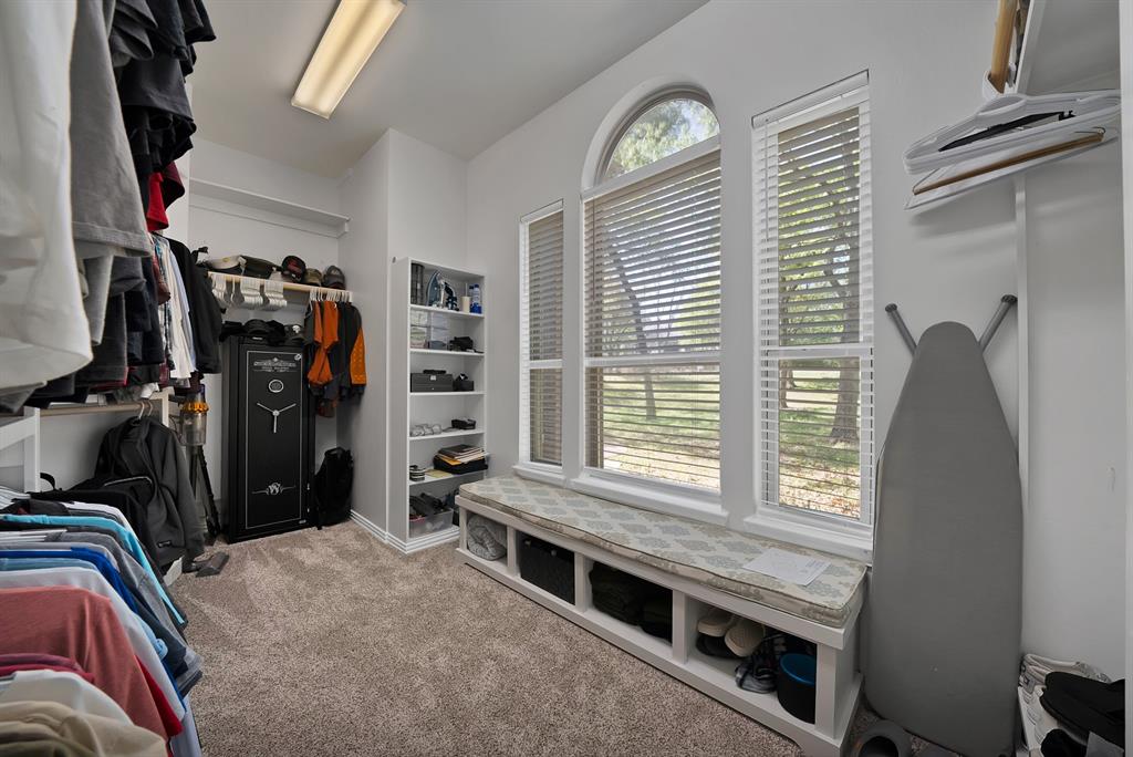 621 Diamond Point Drive Oak Point, TX 75068 - Photo 24 of 40 a view of walk in closet with clothes and shoes