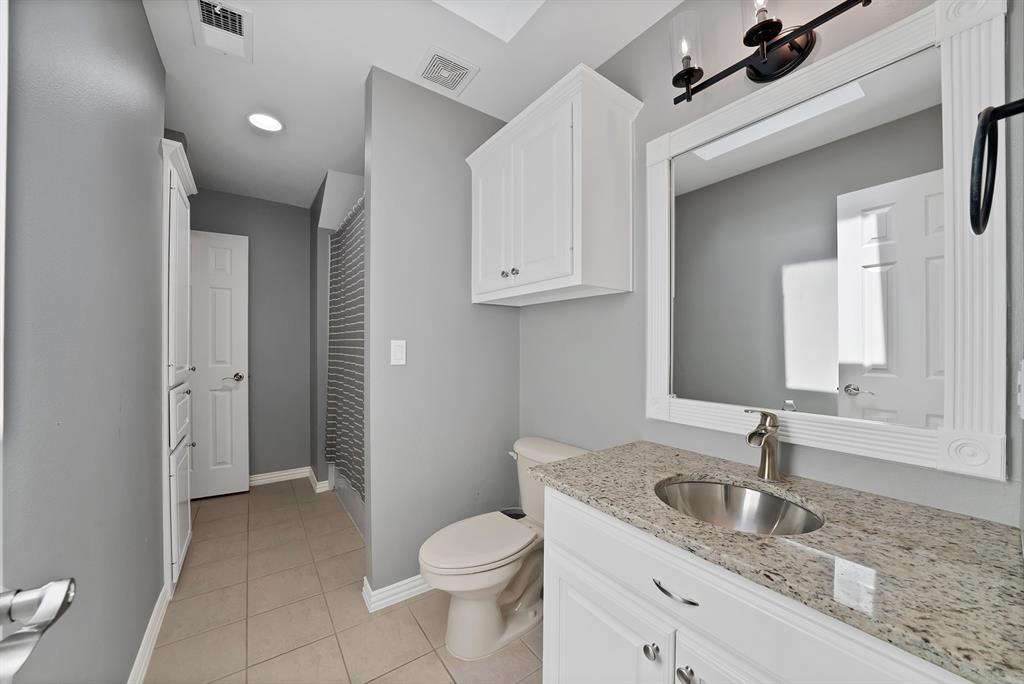 621 Diamond Point Drive Oak Point, TX 75068 - Photo 27 of 40 a bathroom with a granite countertop sink toilet and mirror