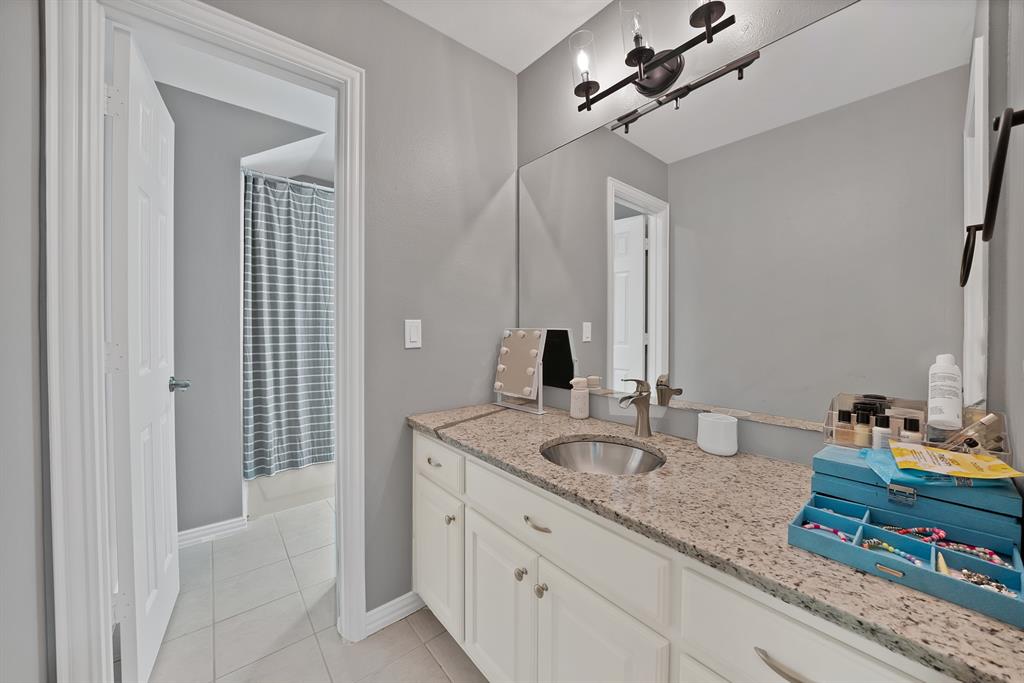 621 Diamond Point Drive Oak Point, TX 75068 - Photo 28 of 40 a bathroom with double vanity sinks and a mirror