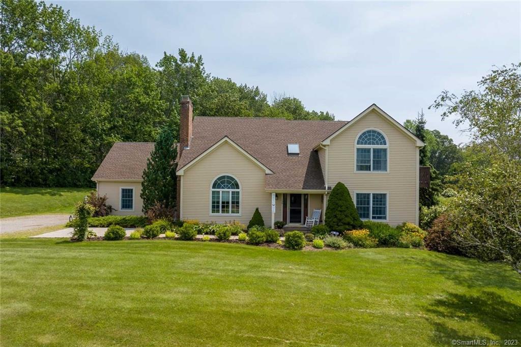 a front view of house with yard and green space