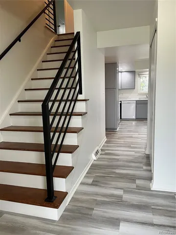 a view of entryway and hall with wooden floor