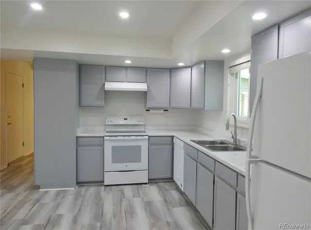 a kitchen with a sink stove and refrigerator