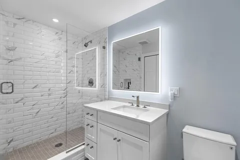 a bathroom with a sink toilet and shower